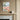Canvas print of a colorful cityscape on a wall with decorative wallpaper.