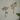 Pair of gold decorative hooks with bird, flowers and bee design on the wall