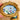 Miniature painting inside a gold ornate frame held by a hand.