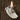 A decorative ceramic dish in a hand shape in ivory colour with blue flowers is used as a candle holder with a candlestick on it.