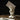Ceramic hand vase made of glazed ceramic is used as a postcard holder on a wooden table.